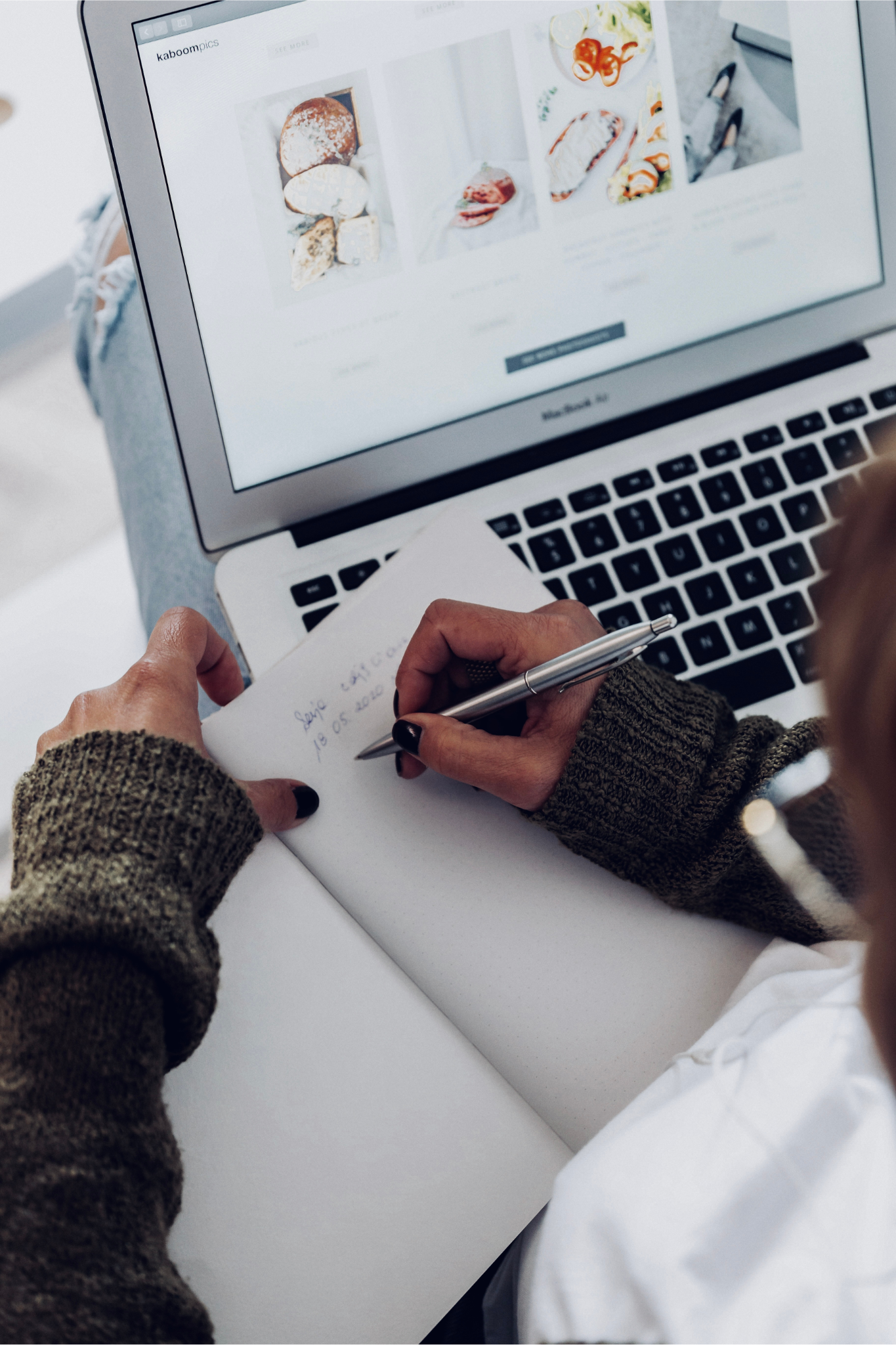 laptop, woman writing in notebook